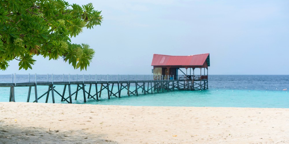 pier-red-roofed-hut-beach-pom-pom-island-malaysia