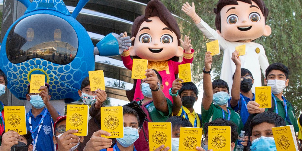 expo2020dubai-mascot-morning-appearances-kids-holding-exhibition-passports 