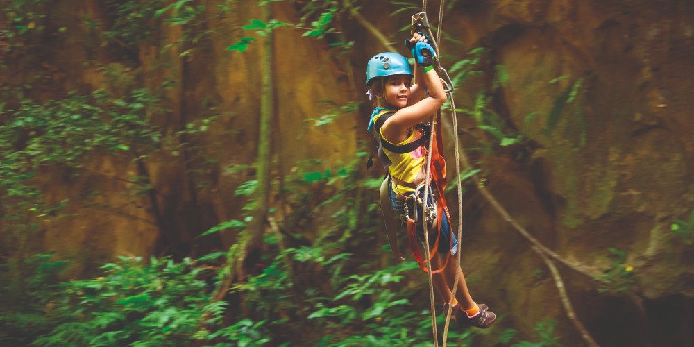 kid-in-safety-gear-ziplining-in-the-jungle-costa-rica-family-holidays-for-easter-2022