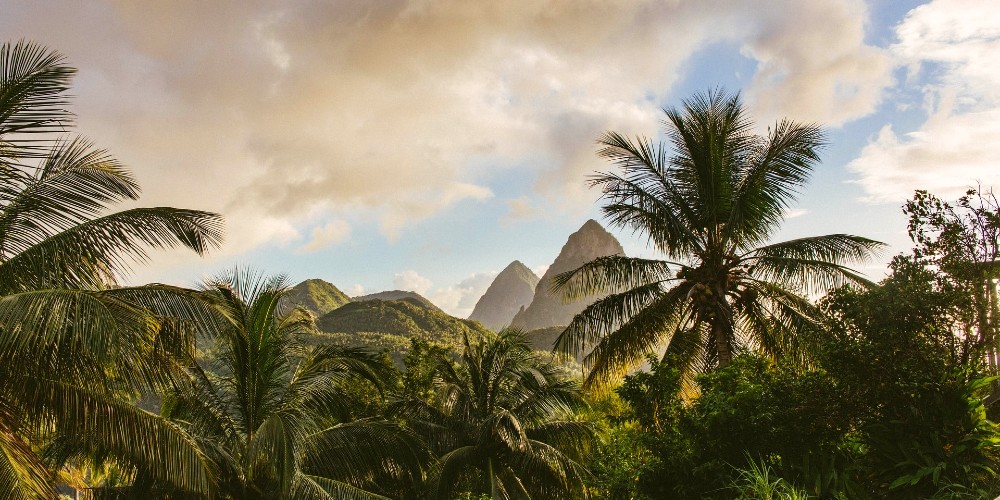 st-lucia-jungle-with-twin-pitons-over-the-palm-trees-under-a-stormy-caribbean-sky-corinne-kutz 