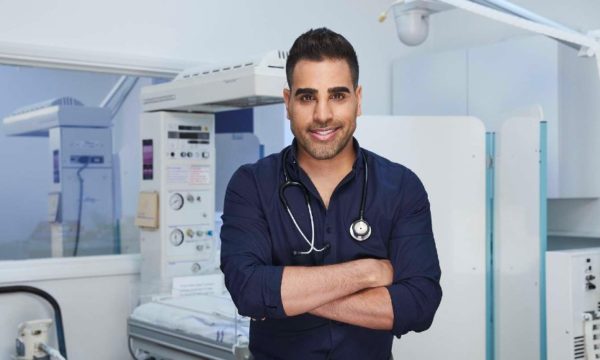 image-of-dr-ranj-singh-in-blue-shirt-with-stethescope-in-clinic-talking-family-health-advice-family-traveller-2022