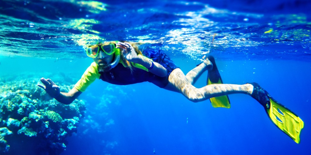 child-snorkelling-underwater-shot-with-coral-halkidiki-family-holidays-summer-2022-family-traveller-guide