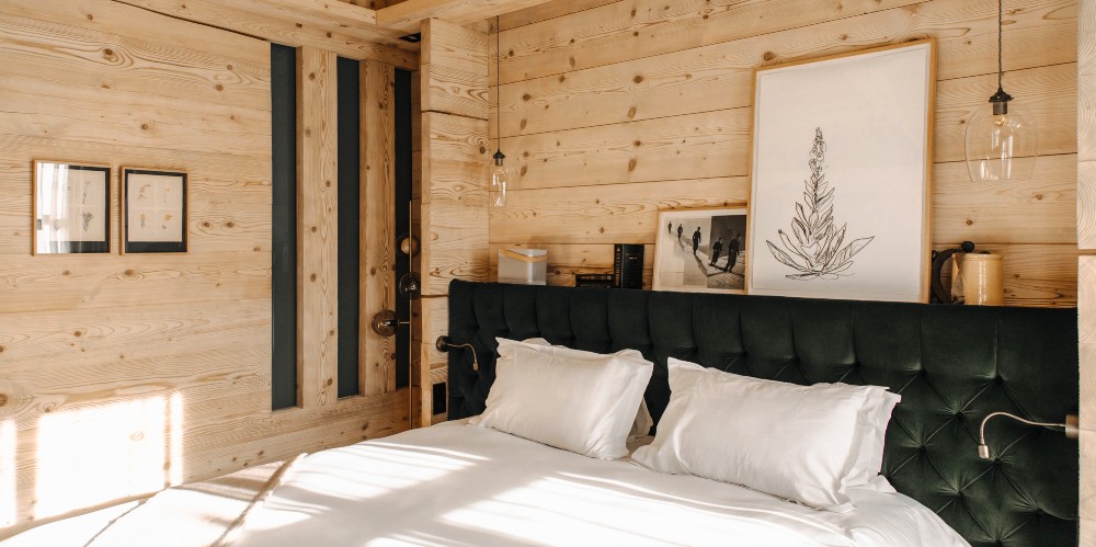 megeve-family-ski-breaks-hotel-alpaga-bedroom-with-wood-walls-double-bed-white-bedlinen