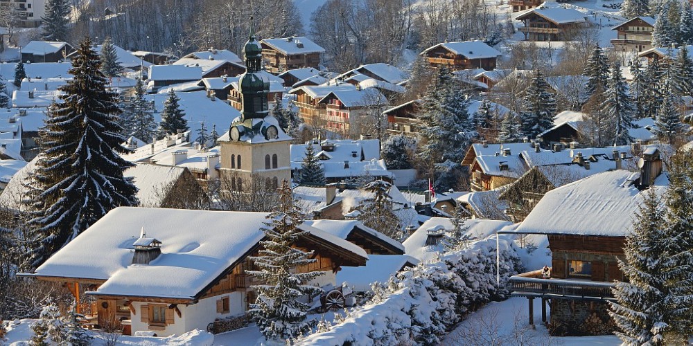 megeve-village-france-snow-covered-rooftops-historic-church-mountain-backdrop-haute-savoie