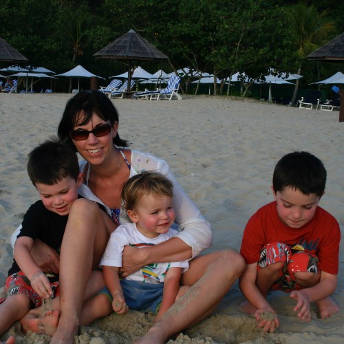 shape-of-a-boy-author-kate-wickers-and-her-three-sons-on-beach-with-sun-umbrellas-and-loungers