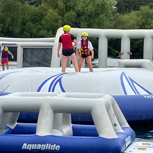 teenagers-playing-in-inflatable-waterpark-on-family-mini-break-at-tattershall-lakes-lincolnshire