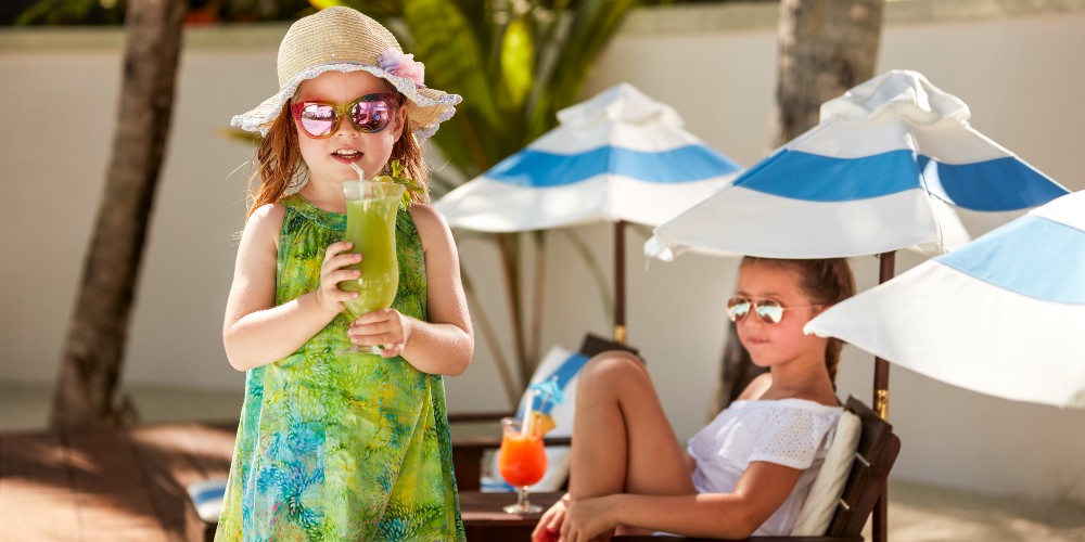 easy-maldives-family-holidays-kids-drinking-mocktails-by-pool-sun-siyam-olhuveli-resort-2022