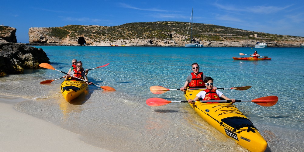 family-kayaking-at-the-blue-lagoon-comino-island-family-holidays-in-malta-2022