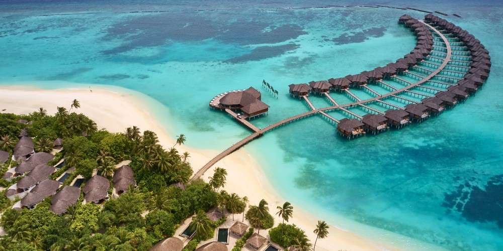 overwater-villas-in-indian-ocean-white-sand-beach-lush-vegetation-iru-fushi-resort-maldives-family-holidays-2022