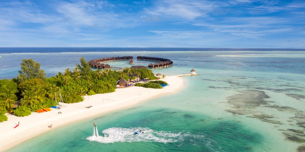sun-siyam-olhuveli-resort-maldives-flyboarding-in-indian-ocean-overwater-villas-white-sand-beach-2022