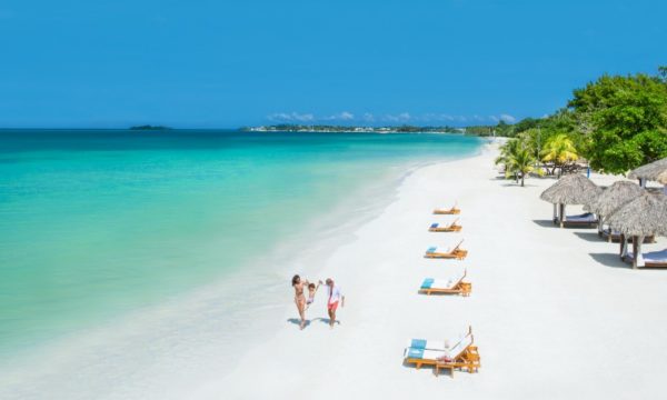 beaches-caribbean-resorts-annual-sale-2022-family-walking-on-seven-mile-beach-jamaica-beaches-negril-resort