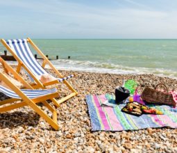 stripy-deckchairs-and-picnic-basket-on-felpham-beach-sunny-day-with-blue-skies-and-clear-seas-2022