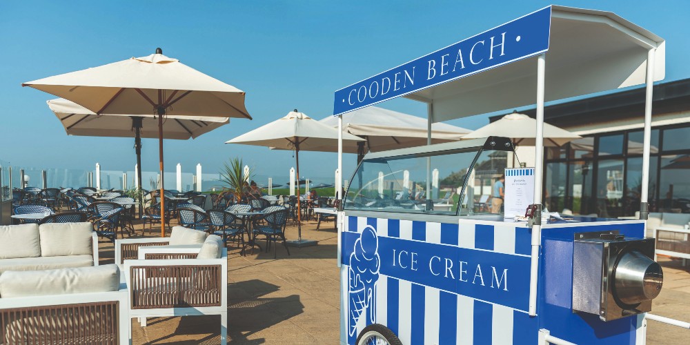 blue-striped-vintage-ice-cream-cart-terrace-cooden-beach-hotel-bexhill-on-sea-east-sussex-2022