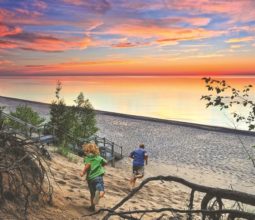 colourful-sunset-lake-beach-michigan-man-and-toddler-running-on-sand-summer-2022
