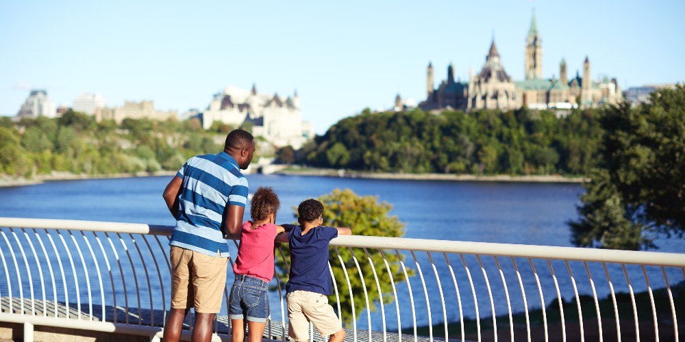 family-looking-at-View-of-Parliament-from-Canadian-Museum-of-History-Ottawa-Tourism-summer-2022