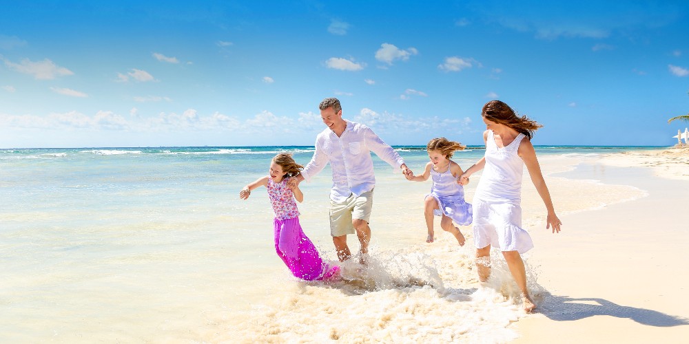 family-playing-on-beach-kenwood-travel-family-summer-holidays-2022