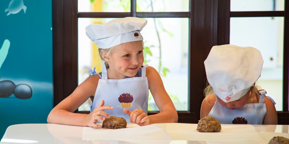 saii-lagoon-maldives-curio-collection-by-hilton-kids-in-tall-chefs-hats-baking-cookies-2022