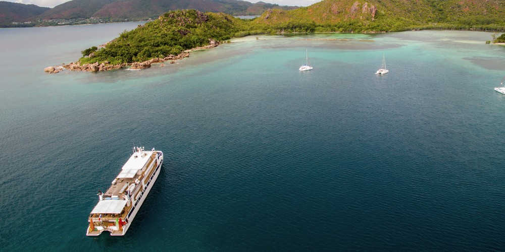 the-pegasos-cruise-ship-in-bay-with-yachts-variety-cruises-seychelles-holidays-family-traveller-2022