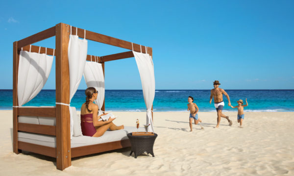 woman-canopy-sun-bed-white-sand-beach-dreams-riviera-cancun-resort-and-spa-mexico-2022
