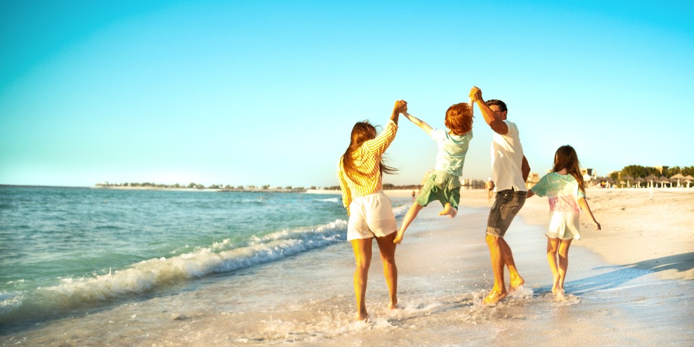 ras-al-khaimah-beach-family-playing-kenwood-travel-holidays-2022