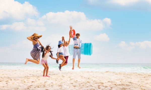 tripbeat-holiday-deals-family-jumping-for-joy-sunny-beach