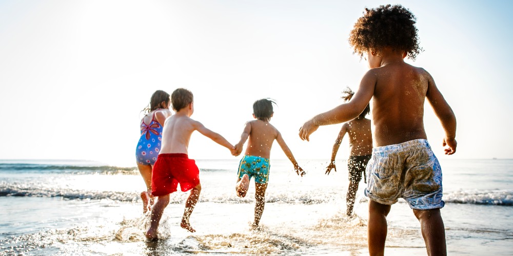 children-beach-running-in-sea-multi-gen-best-family-holiday-destination