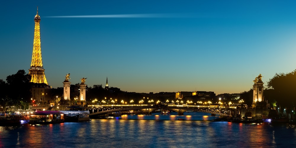 eiffel-tower-lit-evening-seine-bridges-paris-city-breaks