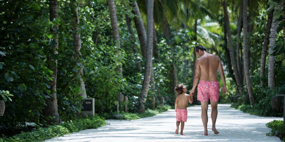 father-son-in-swim-shorts-walking-in-jungle-vakkaru-resort-2022