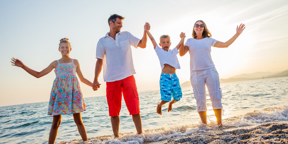 family-jumping-for-joy-in-sea-tripbeat-holiday-competition-2023