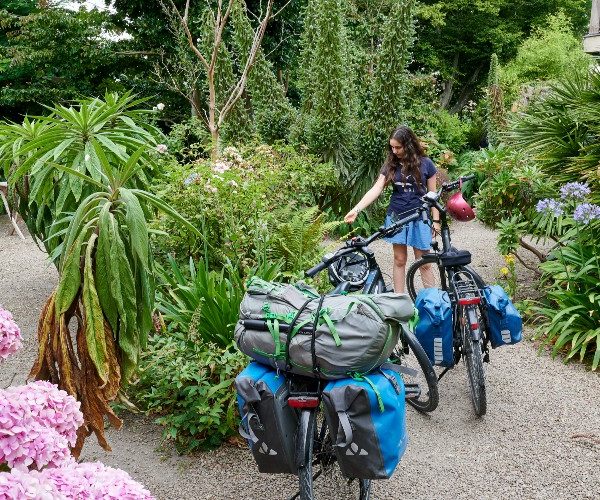 hotel-fuschias-flower-filled-garden-girl-bikes-velomaritime-rudolf-abraham