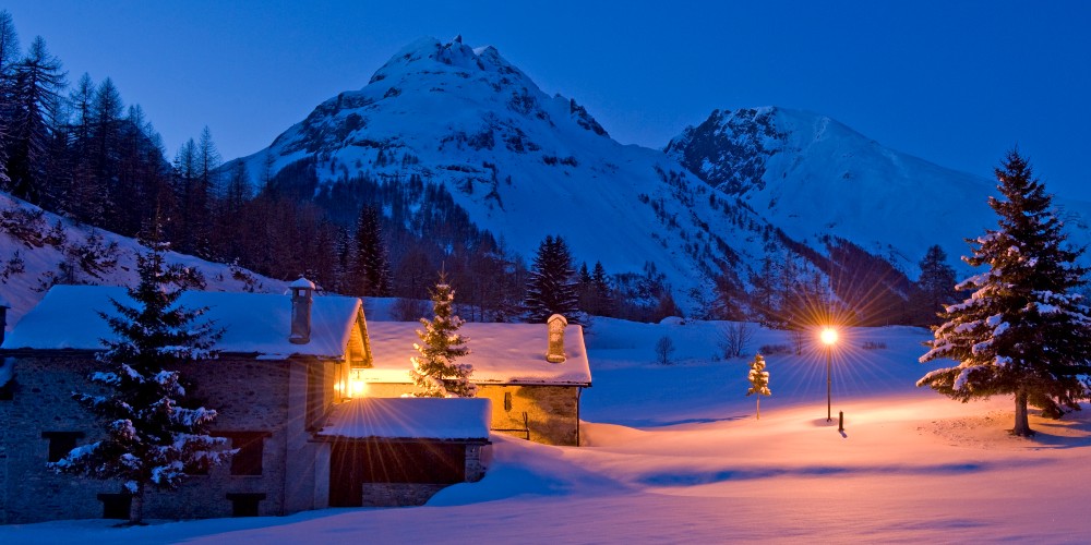 la-thuile-chalets-snow-covered-mountains-italy-evening