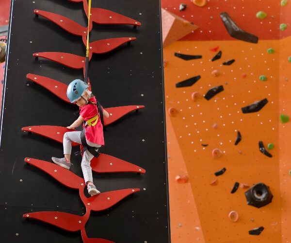 little-girl-on-colourful-climbing-wall