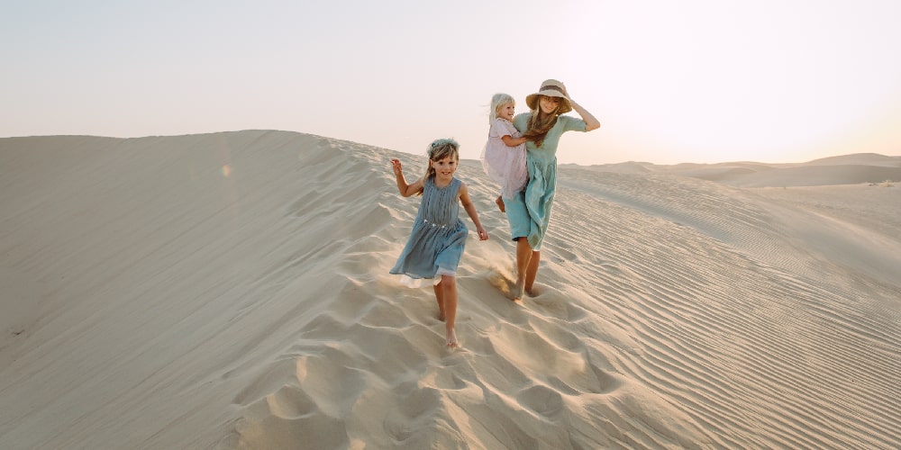 mother-two-daughters-dune-walking-dubai