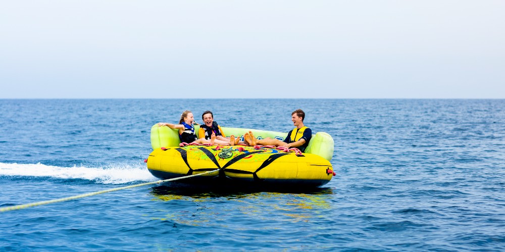 kids-on-inflatable-sofa-being-towed-summer-holidays-2023