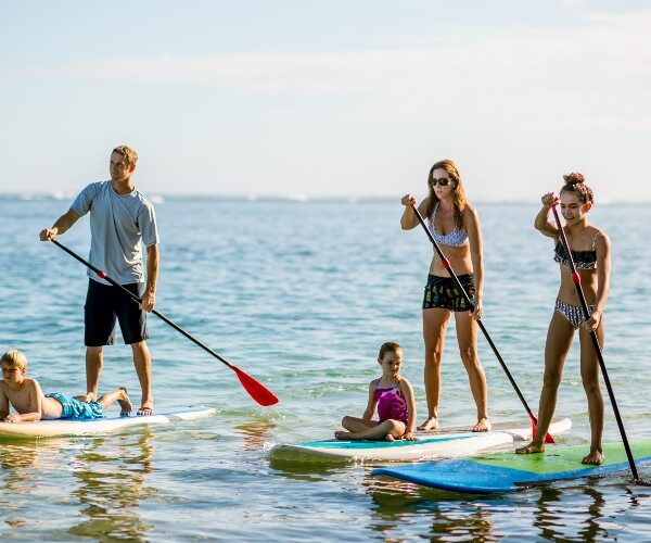family-teenagers-younger-kids-paddleboarding