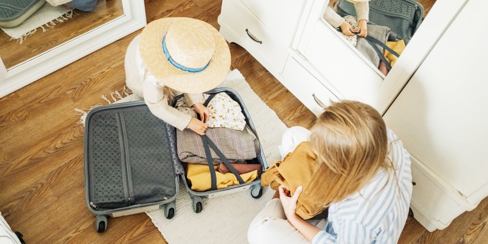 mother daughter packing suitcase
