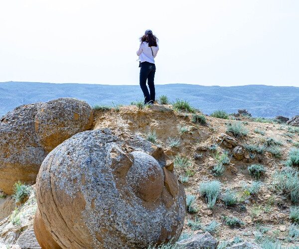 valley-of-the-stone-balls-girl-standing-on-ridge