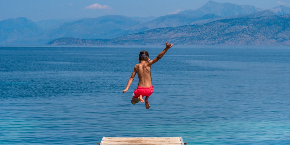 boy-jumping-off-jetty-bella-mare-hotel-corfu