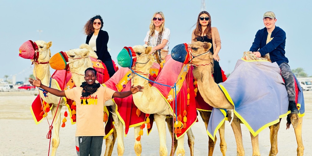 people-riding-camels-with-guide-desert