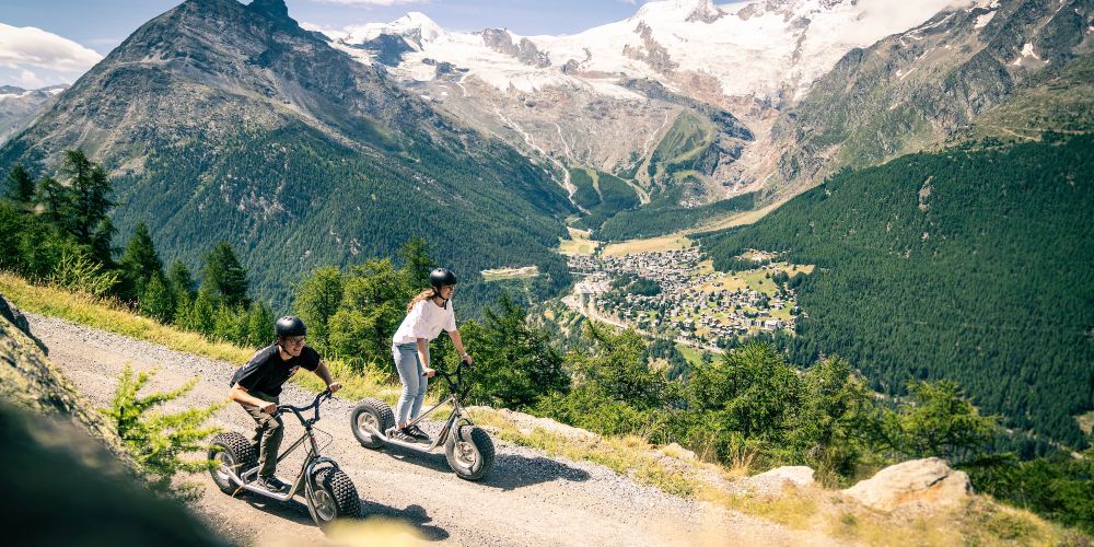 saas-fee-cyclists-summer-mountains-switzerland