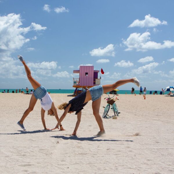 girls-cartwheeling-city-beaches-miami