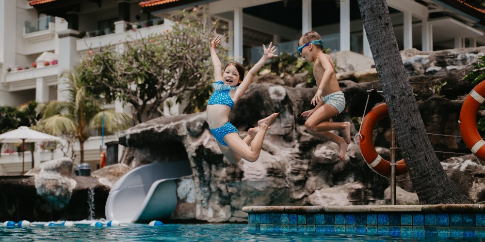 children-jumping-into-pool-hilton-bali-resort