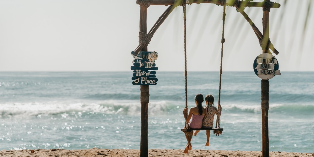 children-on-swing-beach-nusa-dua