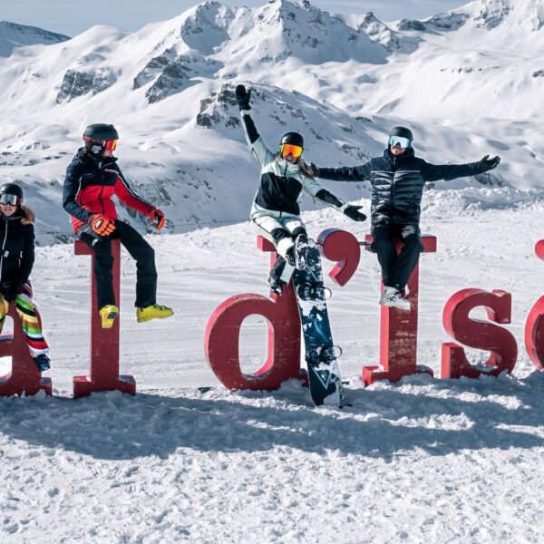 family-skiers-on-val-d-isere-sign