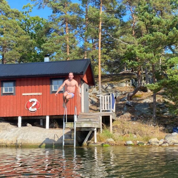 man-jumping-in-lake-family-kayaking-holidays