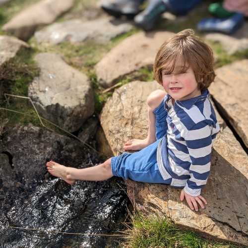 child-cooling-feet-in-stream