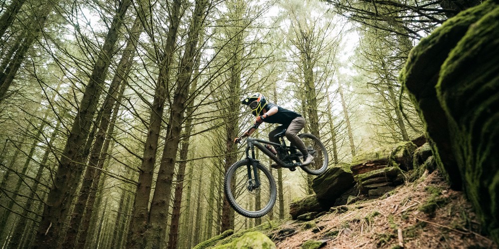 teenager-mountain-biking-forest