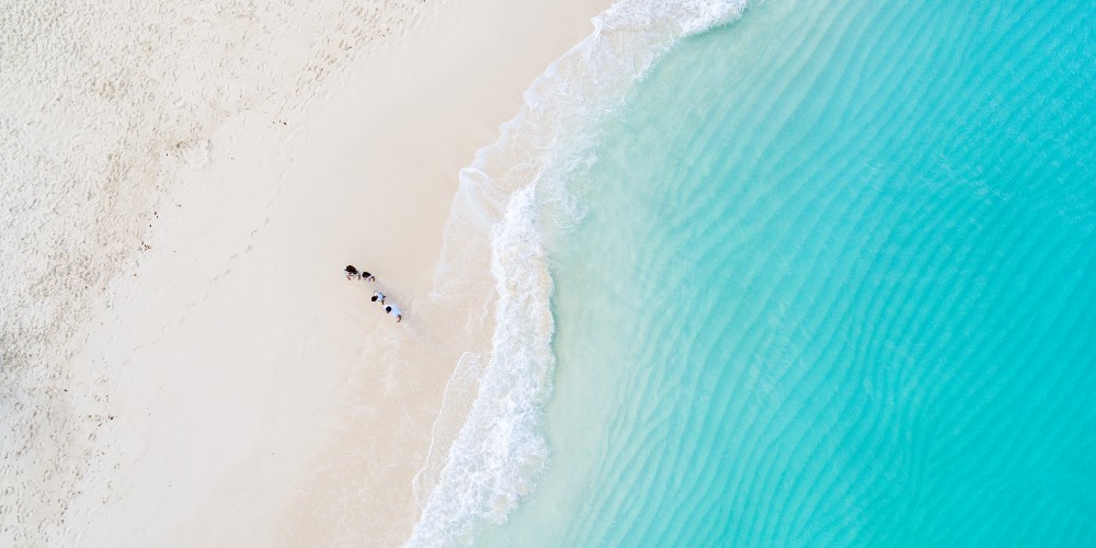 family-walking-on-beach-caribbean