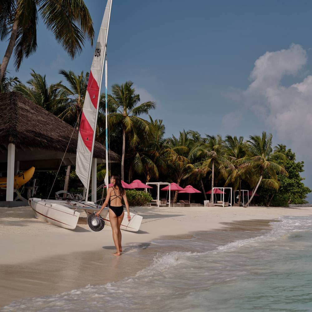 woman-on-beach-with-catamaran