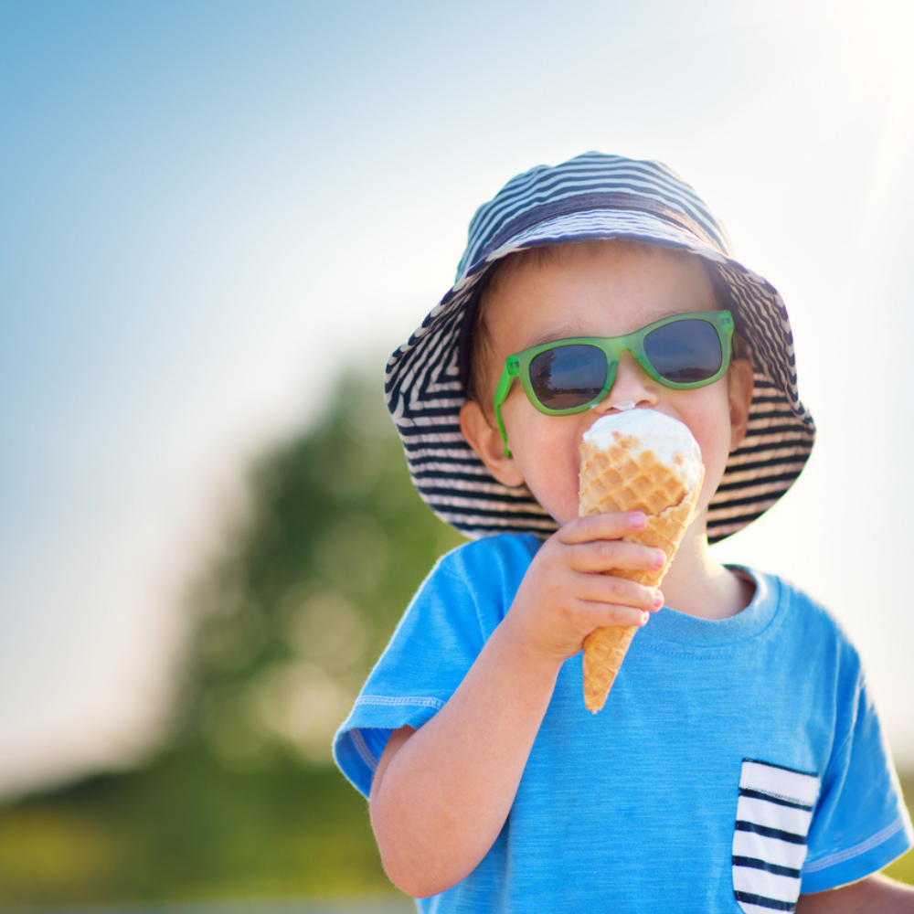 child with ice cream and sunglasses hot weather